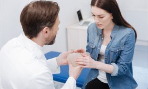 The woman checks the quality of the breast implant.